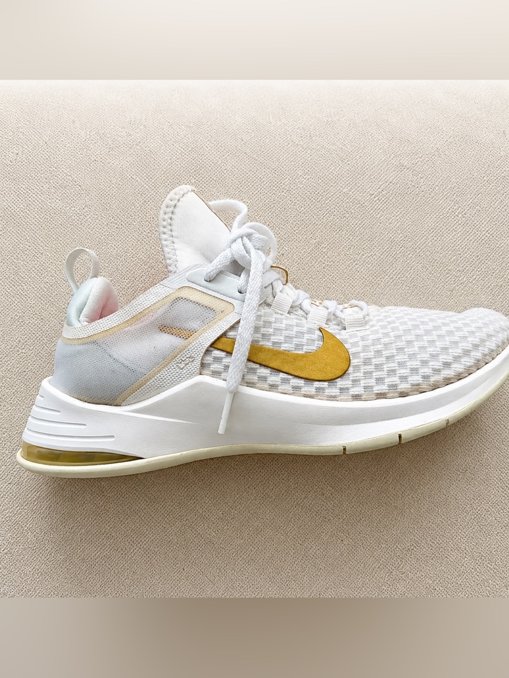 Nike Women's White Athletic Sneakers with Gold Swoosh Accent